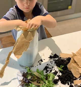 A Person Sitting At A Table Eating Food