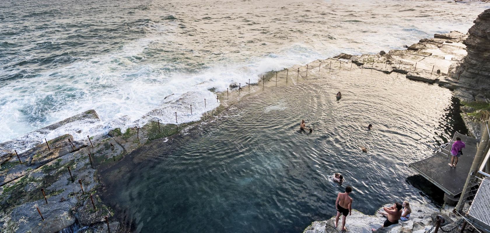 People enjoying a dip in the Bogey Hole, Newcastle.