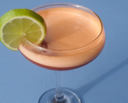 pink cocktail with lime