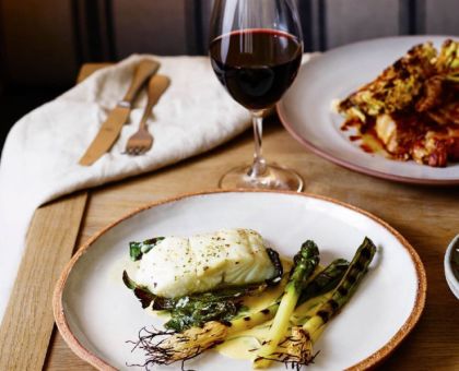 fish and asparagus with a glass Of Wine