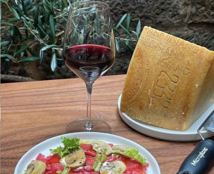 A Plate Of Food And A Glass Of Wine at Mille Vini