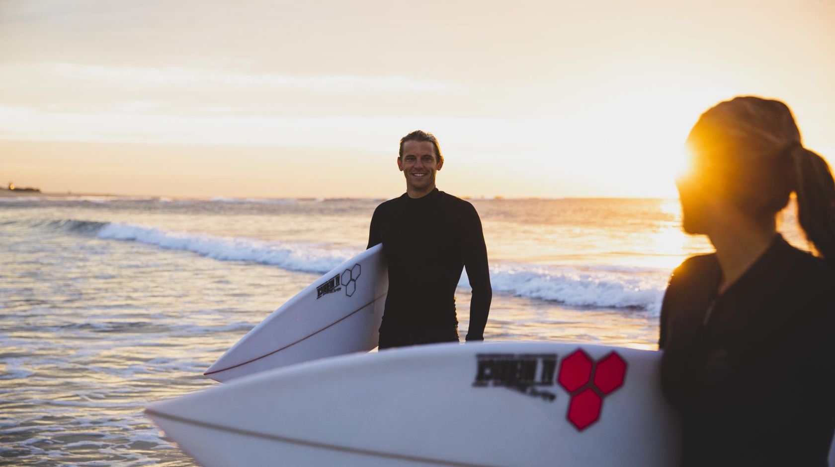 A Man Holding A Surfboard