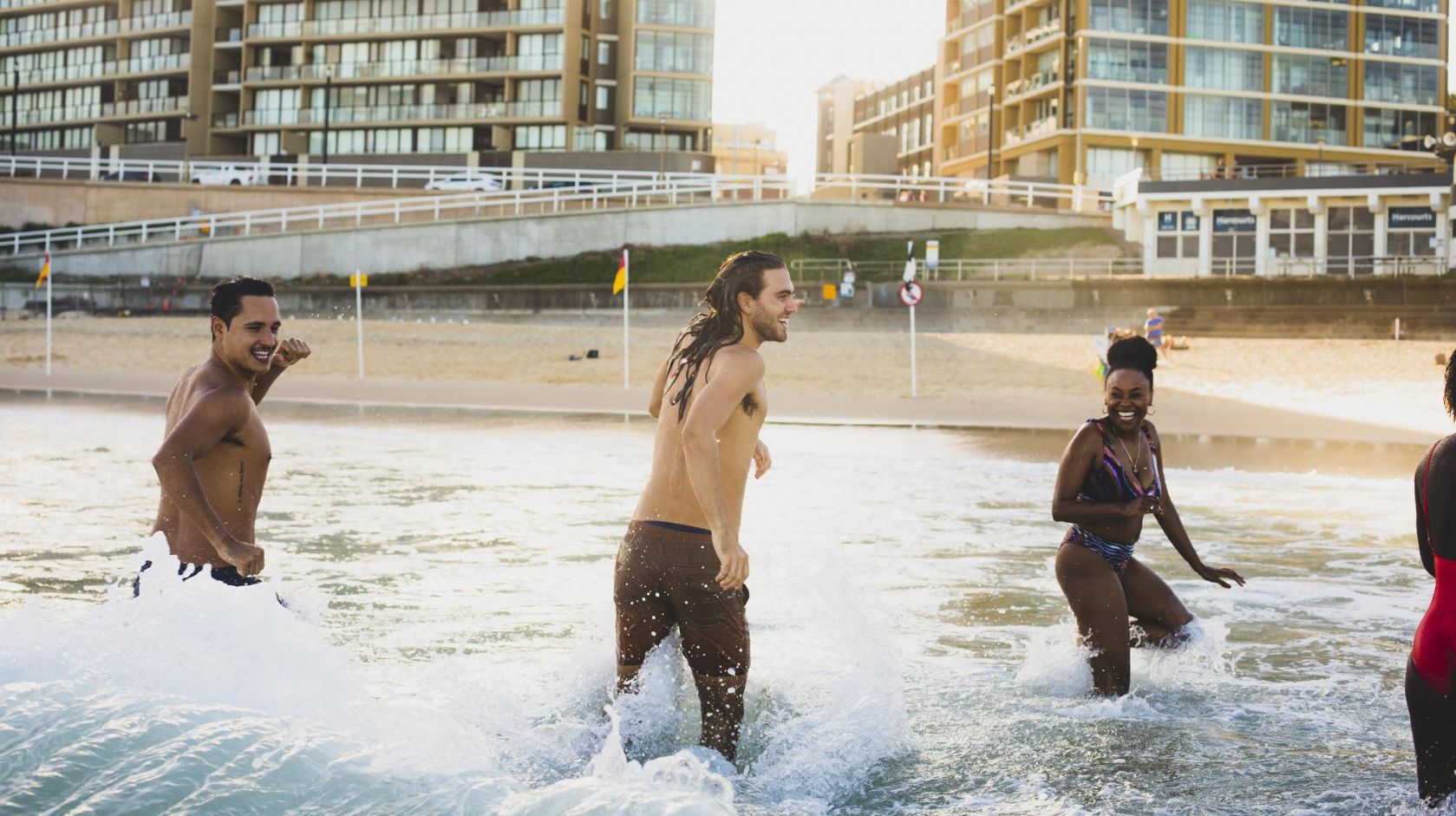 A Group Of People Playing In Newcastle Beach