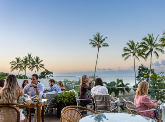 A Group Of People Sitting At Tables