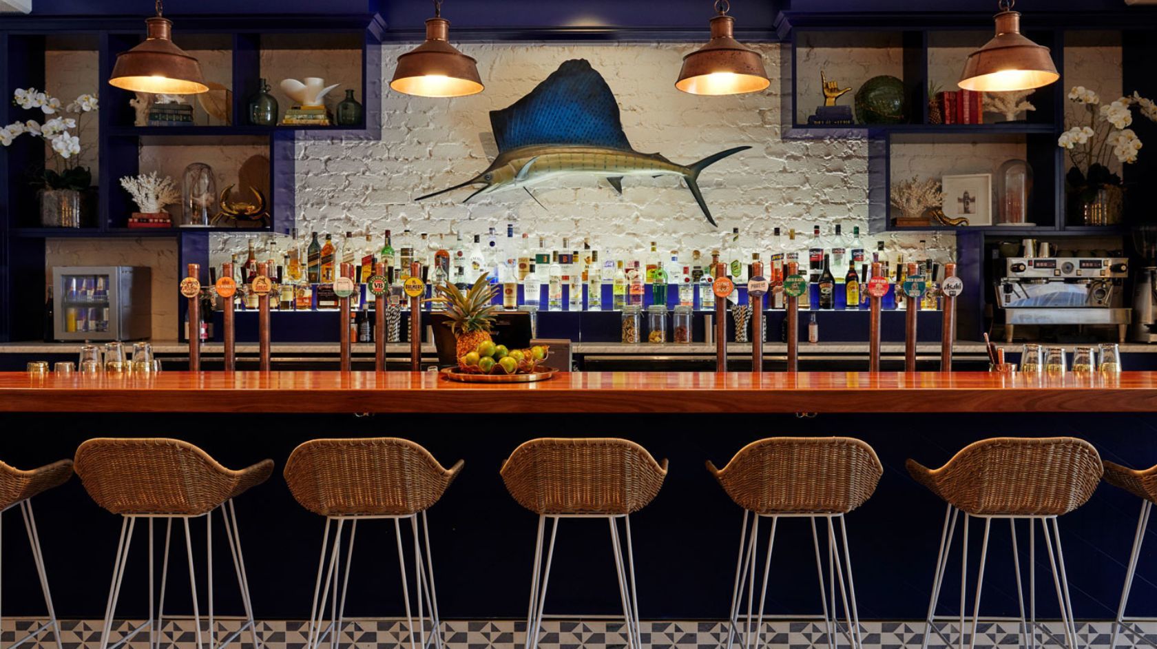 A Bar With Stools And A Bar With A Large Mural On The Wall