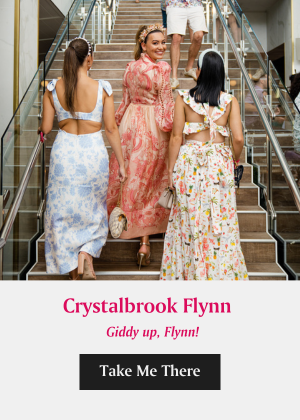 A Group Of Women In Dresses Walking Down A Flight Of Stairs