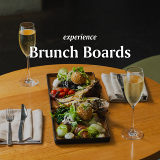 A Plate Of Food And Glasses Of Wine On A Table